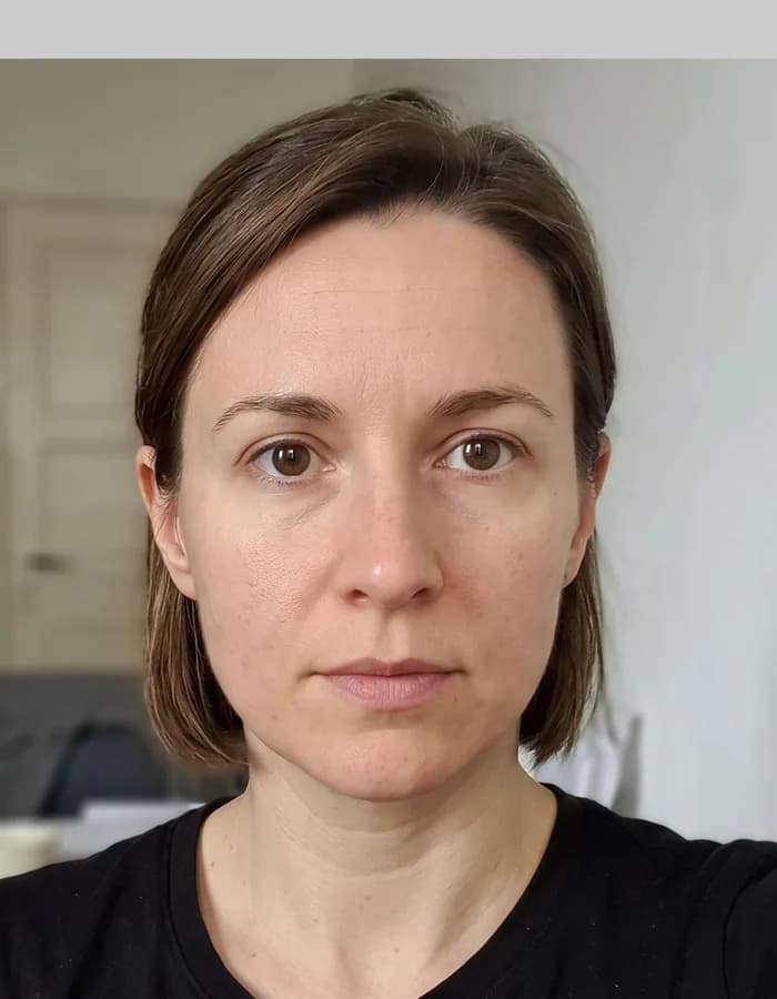 A naturally framed indoor portrait with the full head and shoulders visible